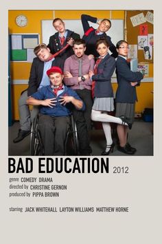 a group of people posing for a photo in front of a board with the caption bad education 2012