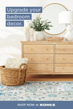 a wooden dresser sitting next to a white vase on top of a blue and white tiled floor