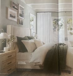 a bed room with a neatly made bed and pictures hanging on the wall above it