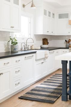 the kitchen is clean and ready for us to use it's white cabinetry