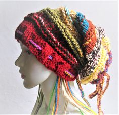 there is a mannequin head wearing a multicolored crochet hat