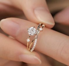 a person holding a diamond ring in their hand