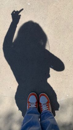 the shadow of a person holding a cell phone