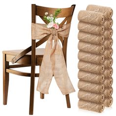 a wooden chair next to a stack of burlocks and a bouquet of flowers