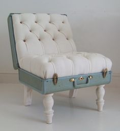 an upholstered bench with buttons on the back and legs is shown in front of a white wall