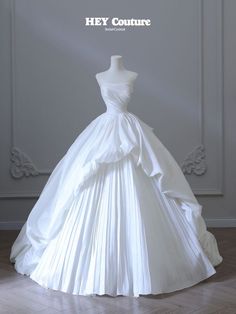 a white wedding dress on display with the words hey couture written above it