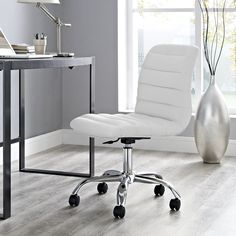 a white office chair sitting in front of a desk with a vase on top of it