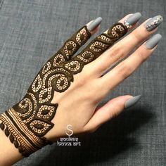 a woman's hand with henna on it