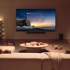 a living room with two couches and a flat screen tv mounted on the wall