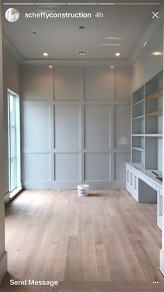 an empty room with white walls and wood flooring is shown in the foreground