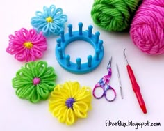 crochet flowers, yarn and scissors on a table