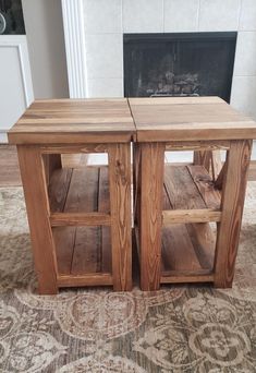 two wooden tables sitting next to each other on top of a carpeted floor in front of a fireplace