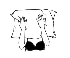 a woman hiding her head under a pillow with her hands on top of the pillow