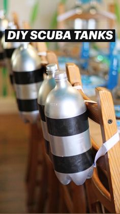 there are many water bottles lined up on the table with ribbons tied around their necks