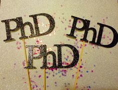 there are two cake toppers that say pdd and pnd on sticks with sprinkles