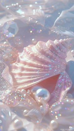 an image of a shell and pearls in the water