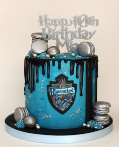 a birthday cake decorated with blue icing and silver decorations