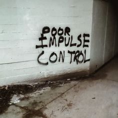 graffiti written on the side of a building reads poor empulse control