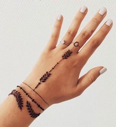 a woman's hand with a tattoo on it