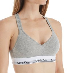 Highly sought after, highly comfortable bra with instantly recognizable Calvin Klein logos and push-up padding for a flattering lift. Made of cotton, modal, polyester and elastane. Wireless, contour/t-shirt cup has a medium graduated push-up bump ridge along bottom and side for enhanced cleavage. Cotton-blend cup overlay has a soft, smooth finish. Flattering neckline with a tall center front. Exposed elastic Calvin Klein underband secures fit and lends light support. Sides and back are self-line Calvin Klein Medium Support Sports Bra For Workout, Cotton Workout Bra, Fitted Seamless Calvin Klein Bra, Calvin Klein Stretch Seamless Sports Bra, Calvin Klein Fitted Seamless Bra, Calvin Klein Seamless Fitted Bra, Cotton Nursing Bra For Loungewear, Calvin Klein Seamless Bra, Cotton Bra With Padded Cups