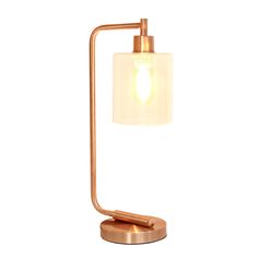 a table lamp with a white shade on it's side and a gold base