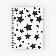 a spiral notebook with black stars on it