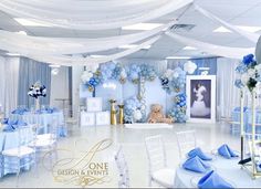 a white and blue themed event with balloons