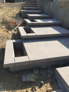 concrete steps are lined up in the dirt