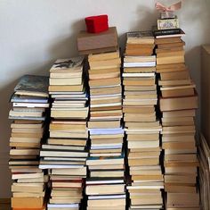 a stack of books sitting on top of a wooden table