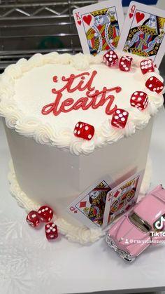 a birthday cake with playing cards and dice on it