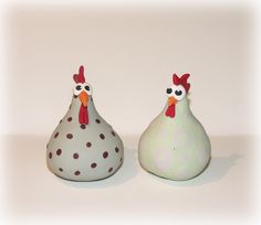 two ceramic chickens sitting next to each other