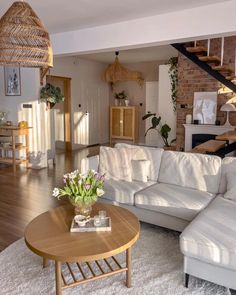 a living room filled with furniture and a staircase