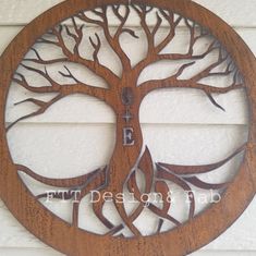 a wooden circle with a tree cut out of it's sides and the words go e on it