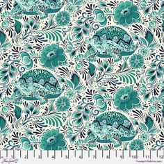 a blue and white floral print fabric with green flowers on the side, in front of a