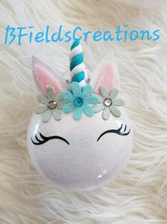 a white unicorn ornament with flowers on it