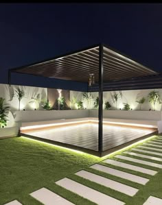 an outdoor area with grass and steps lit up at night