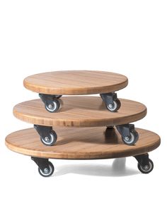 three wooden trays stacked on top of each other, with wheels attached to them