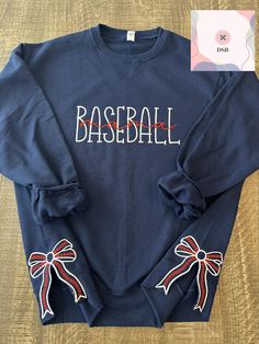 a baseball shirt with bows on the sleeves