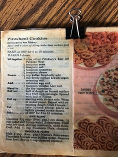 an old recipe book is open on a table