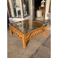 a coffee table with glass top sitting on the sidewalk