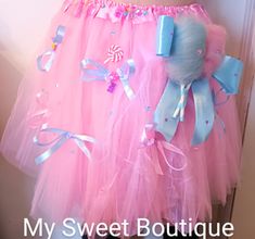 a pink tutu skirt with blue bows and candy canes