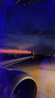 an airplane wing at night with the lights on