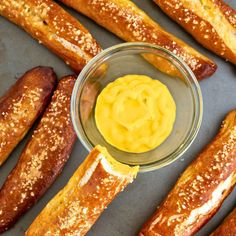 some bread sticks with mustard in a glass bowl