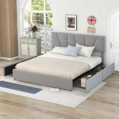 a bed with drawers underneath it in a room