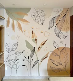 the wall is decorated with flowers and leaves in an artistic manner, as well as plants