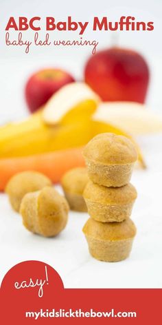 a stack of doughnuts sitting on top of each other with apples and bananas in the background