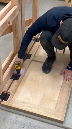 a man is working on some wood planks