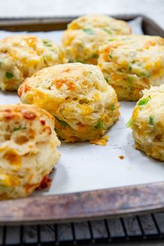 cheddar - scallion biscuits on a baking sheet with the words cheddar - scallion biscuits