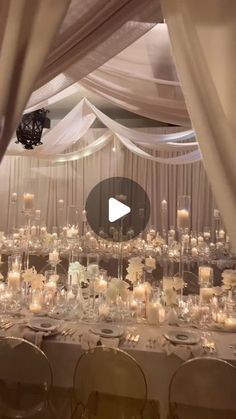 an image of a table set up for a wedding reception with candles and flowers on it