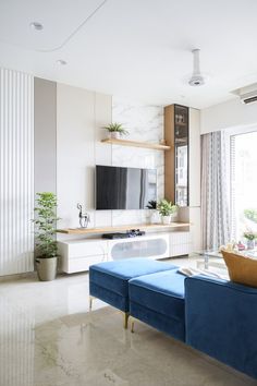 a living room filled with furniture and a flat screen tv on top of a wall